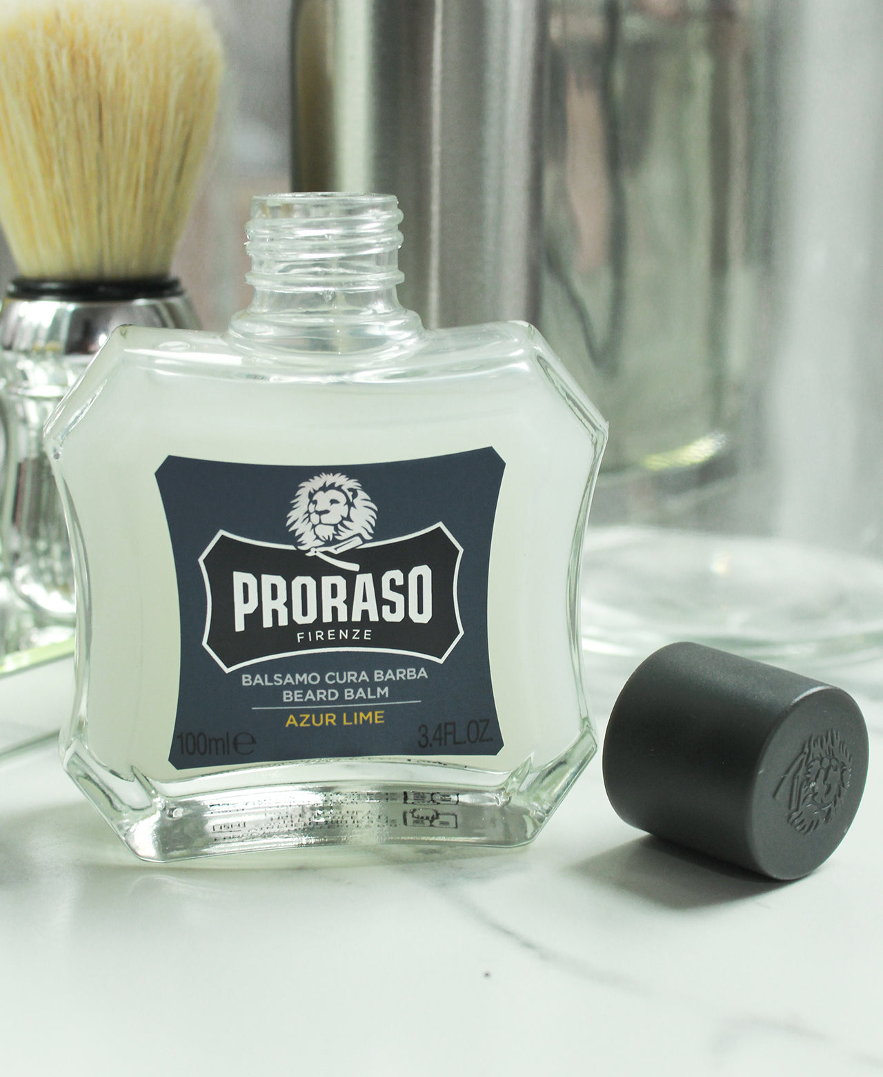 Azur Lime Beard Balm sitting on marble counter with Professional Shave Brush in background