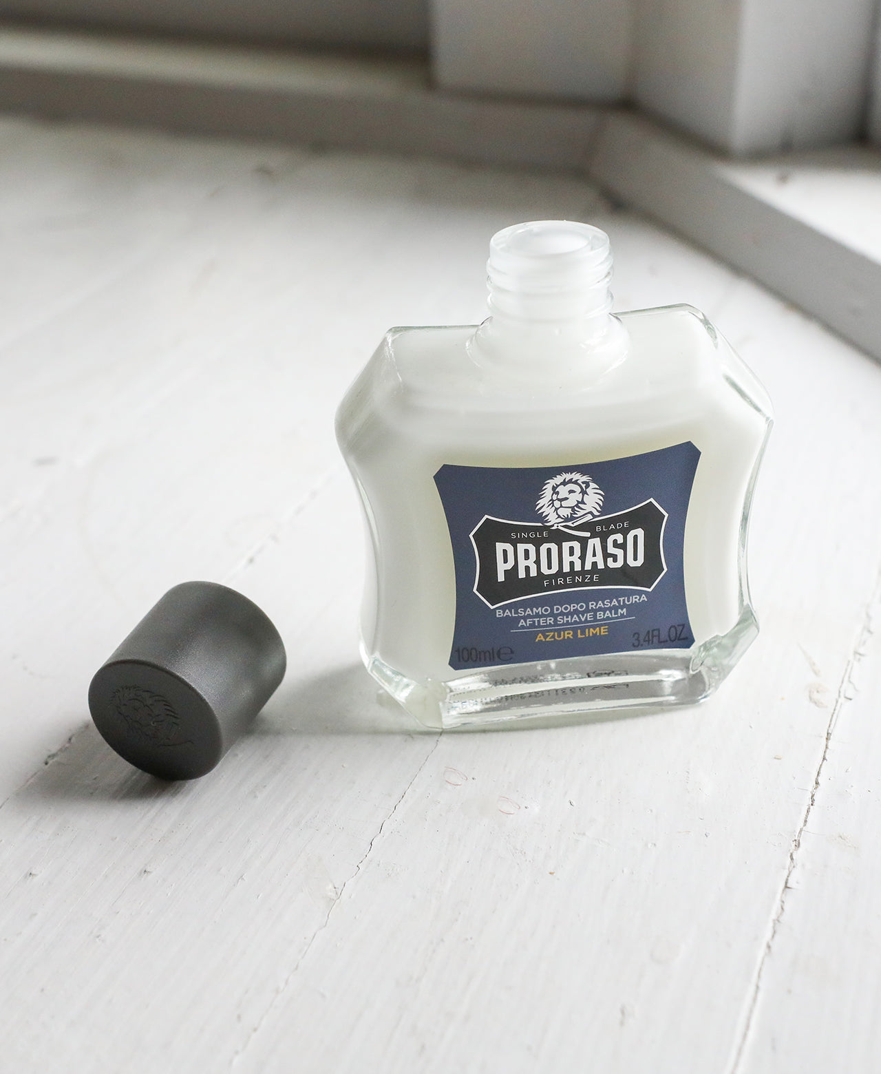 Azur Lime Beard Balm with open lid sitting on white table