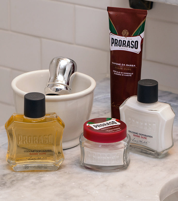  Coarse Beards After Shave Lotion, Proraso Coarse Beards Pre-Shave, Coarse Beard Shave Cream Tube, Proraso Coarse Beards After Shave Balm with shave bowl and Proraso Professional Shave Brush sitting on bathroom counter.
