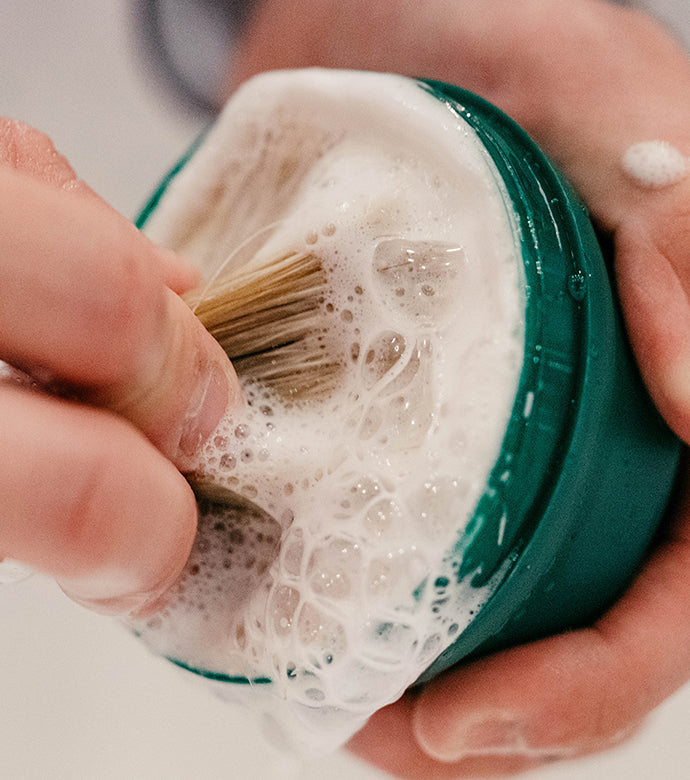 A lather being made with Refreshing Shave Soap in a Bowl and a Professional Shave Brush with a mans two hands