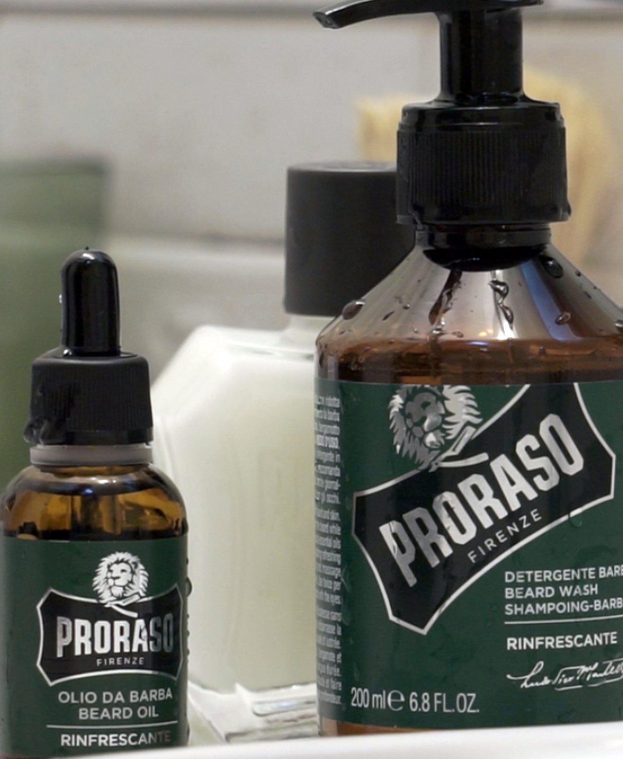 Refresh Beard Oil and Refresh Beard Wash sitting on next to sink on bathroom counter with Beard Balm in background