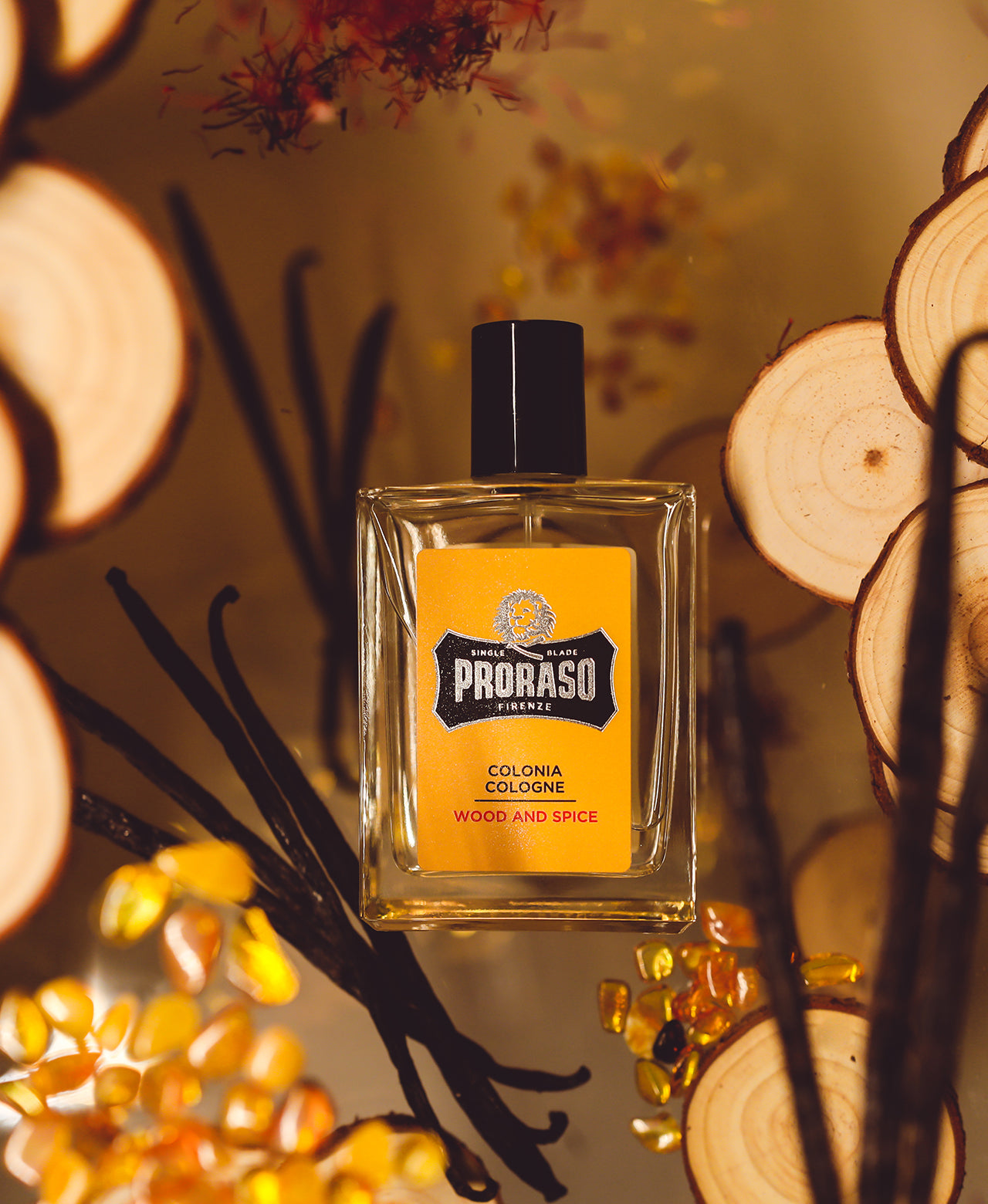 Wood & Spice Cologne surrounded by ingredients Cedar Wood, Vanilla, Saffron and Amber