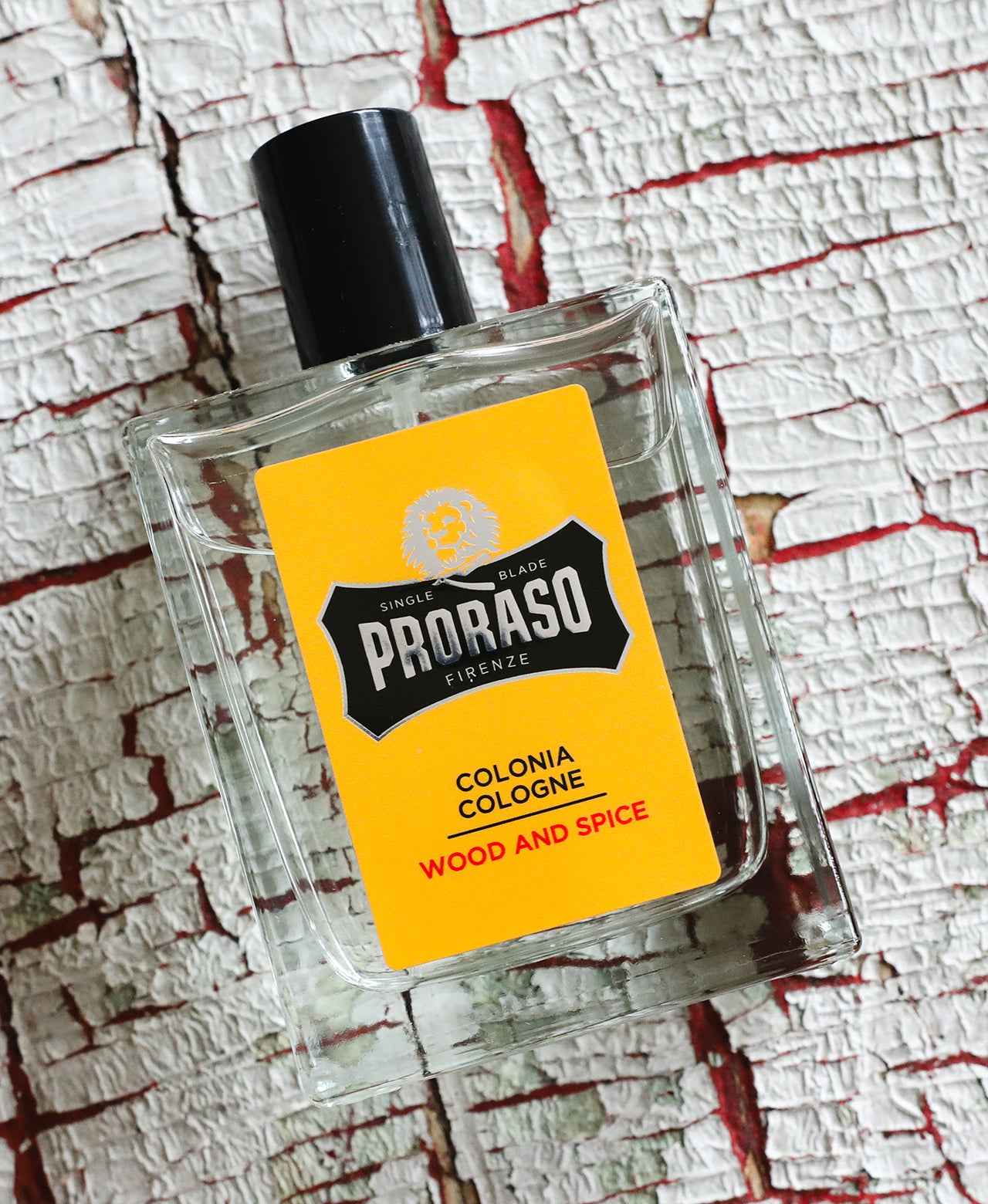 Wood & Spice Cologne sitting on top of wood textured background