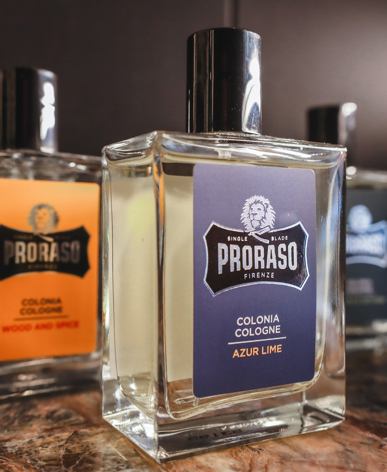 Wood & Spice, Azur Lime and Cypress & Vetyver Colognes sitting on a brown marble table