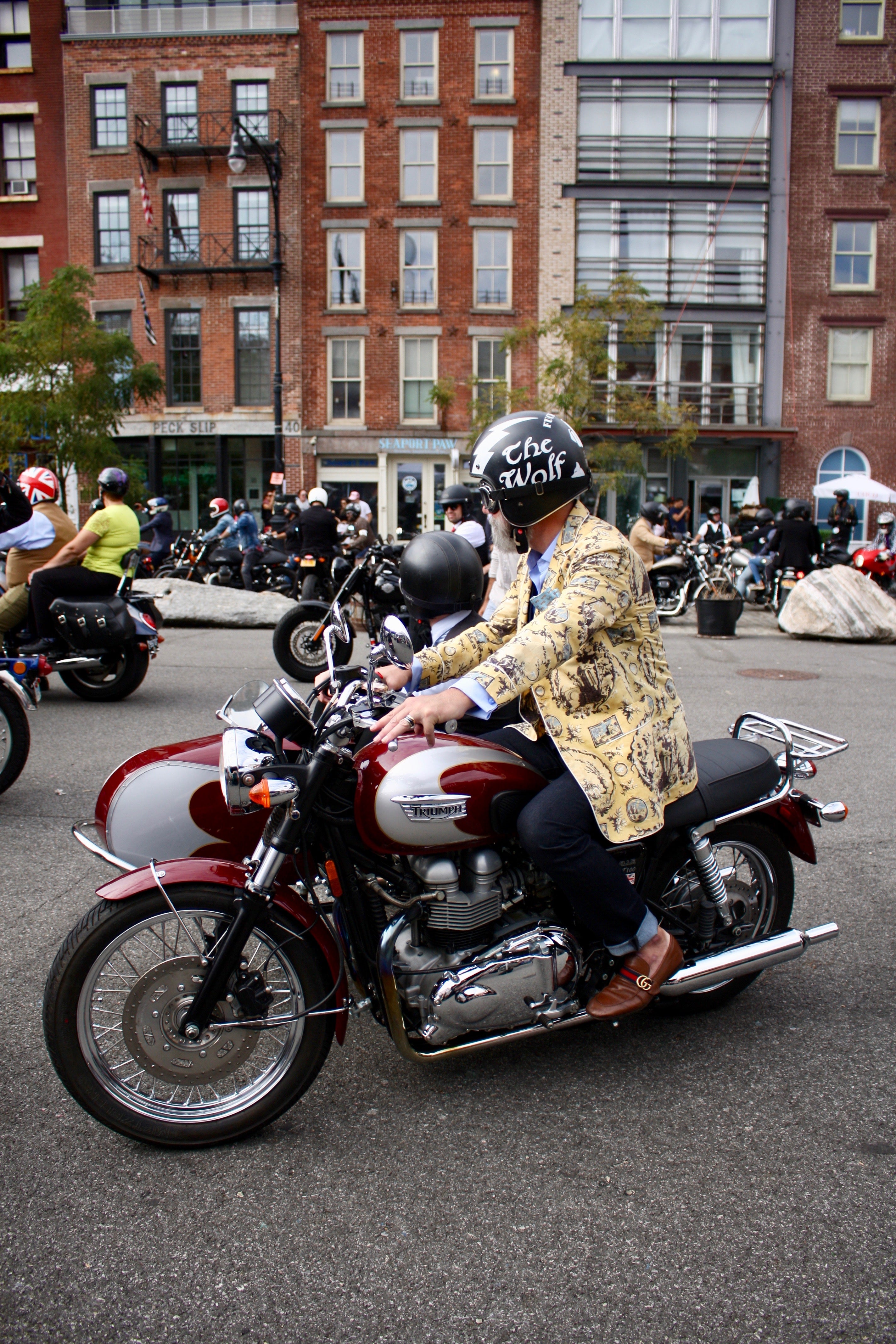 Man in yellow toile blazer driving by on his motorcyle