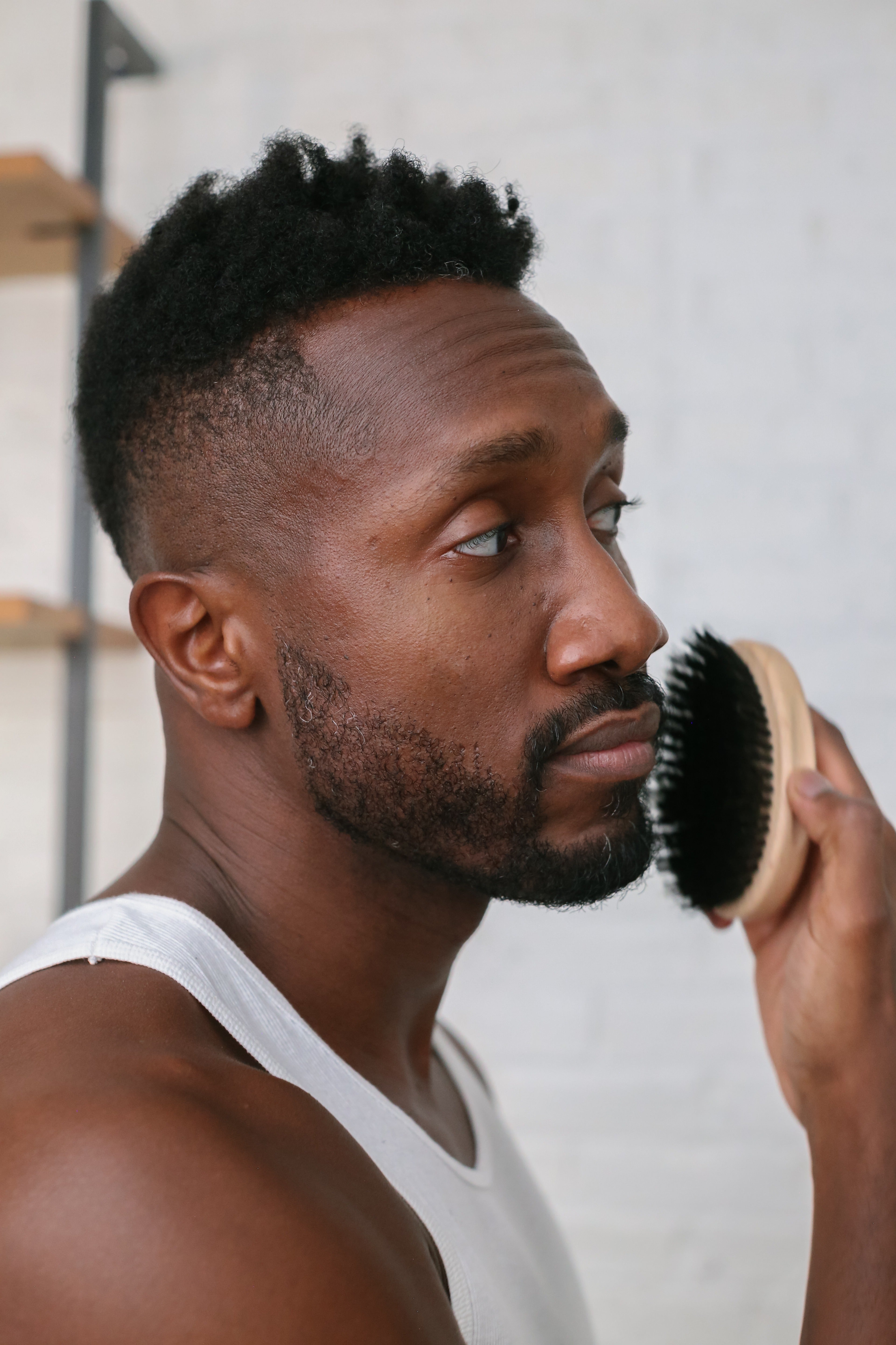 Gentleman brushing his beard with the wood-handled Proraso military brush
