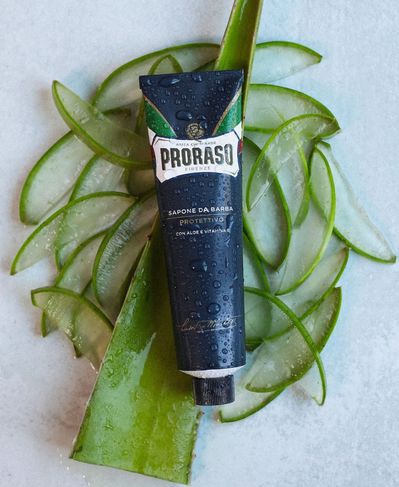 Protective Shave Cream sitting on slices of Aloe Vera