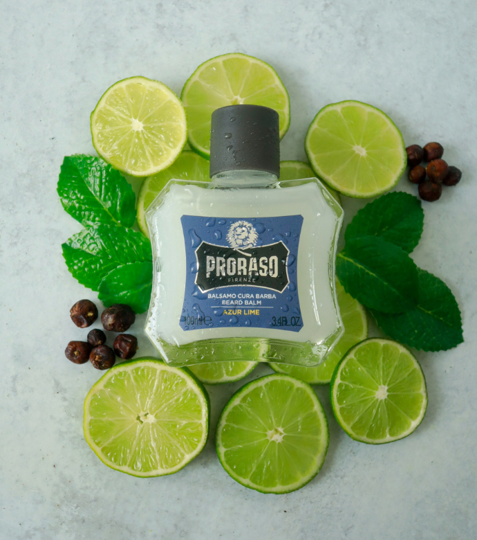 Bottle of Azur Lime Beard Balm sitting on ingredients Lime, Lemon, Mint and Juniper Berries 