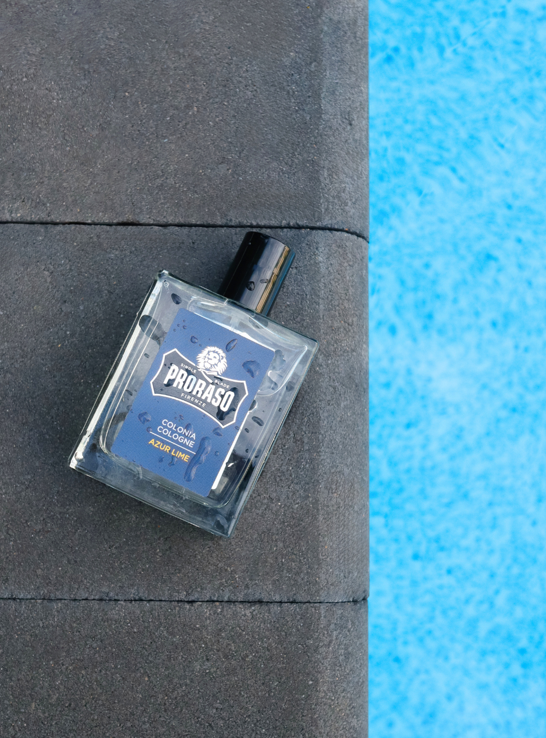 Bottle of Azur Lime Cologne next to a pool
