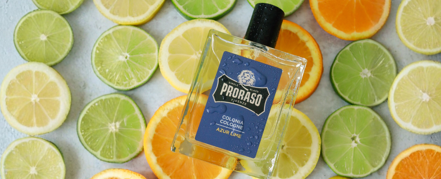 Azur Lime Cologne sitting on slices of ingredients Lime, Lemon and Orange