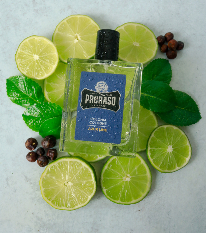 Bottle of Azur Lime Cologne laying on ingredient slices of Lime, Lemon, Mint and Juniper Berries 