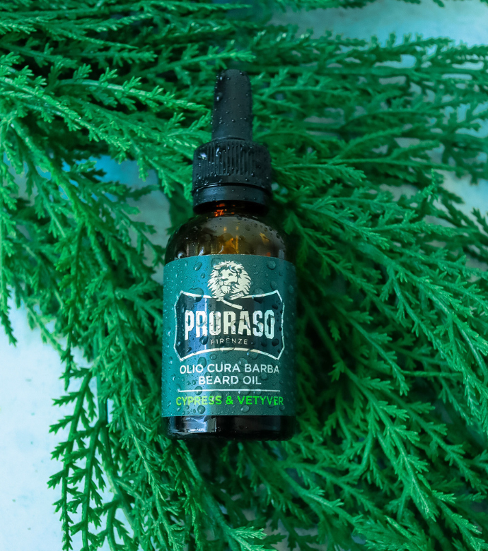 Cypress & Vetyver Beard Oil laying on Cypress Branch 