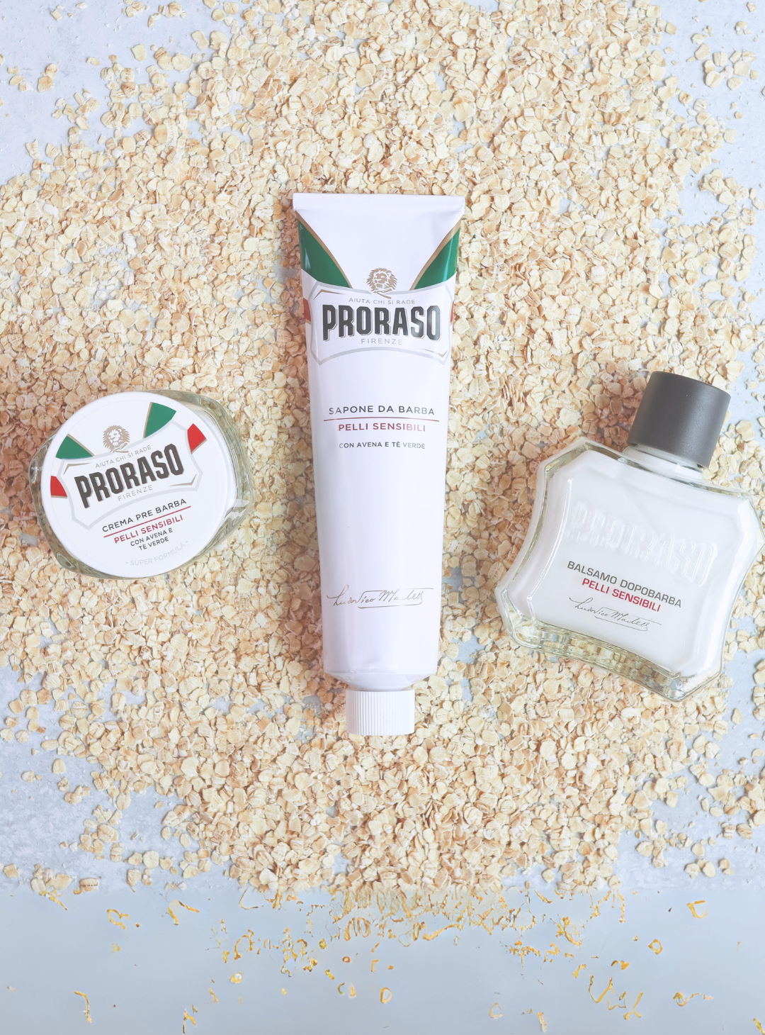 Sensitive Formula Pre-Shave Cream, Shave Cream Tube and After Shave Balm sitting on it's main ingredient Oatmeal 